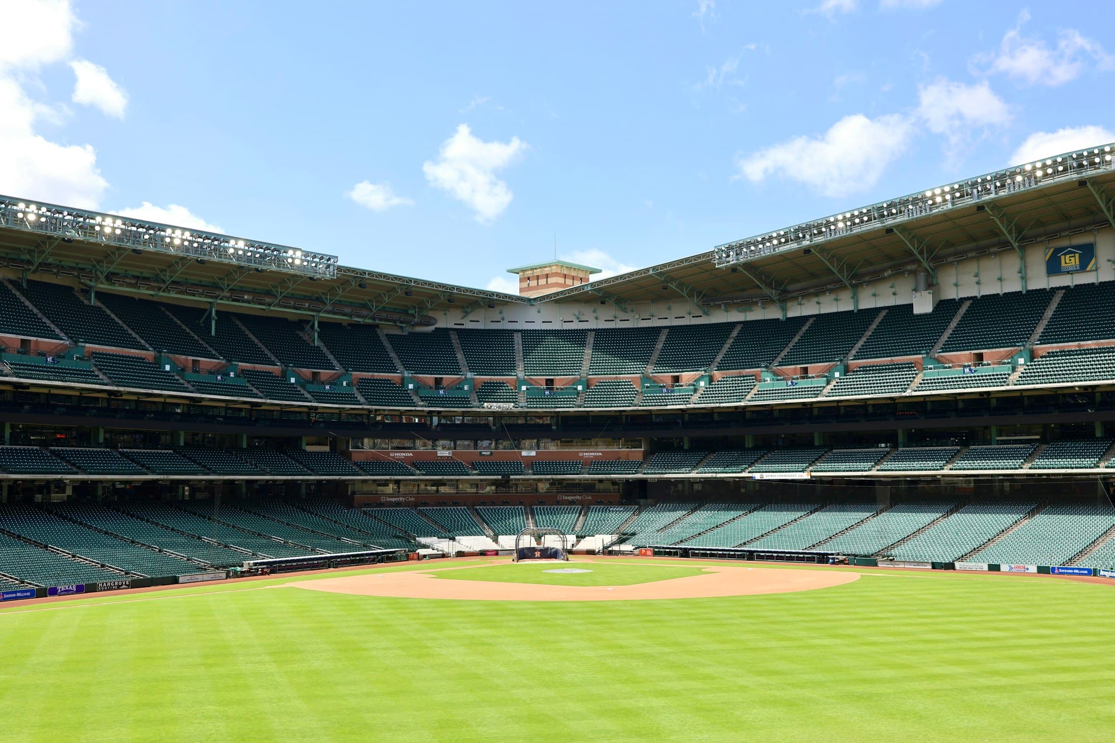 A prepared ball field waiting for players and an umpire
